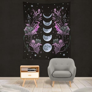 May include: A black tapestry with a floral design and five phases of the moon in shades of purple and blue. The tapestry is decorated with stars and crosses.