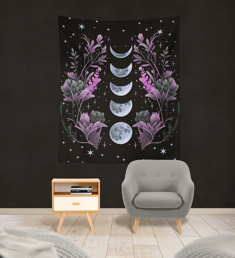 May include: A black tapestry with a floral design and five phases of the moon in shades of purple and blue. The tapestry is decorated with stars and crosses.