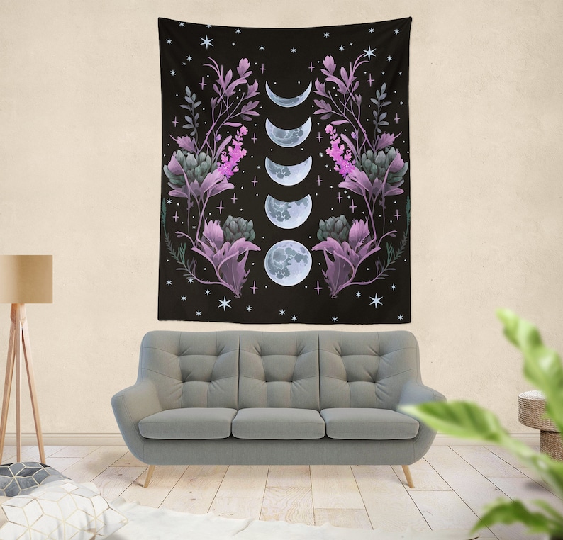 May include: A black tapestry with a floral design and a series of moons in different phases. The flowers are purple and green, and the moons are white.