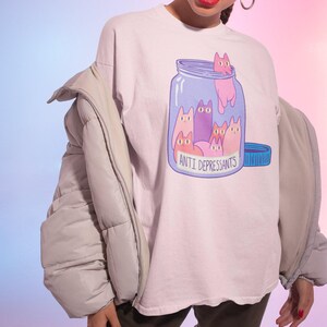 a woman wearing a t - shirt with cats on it