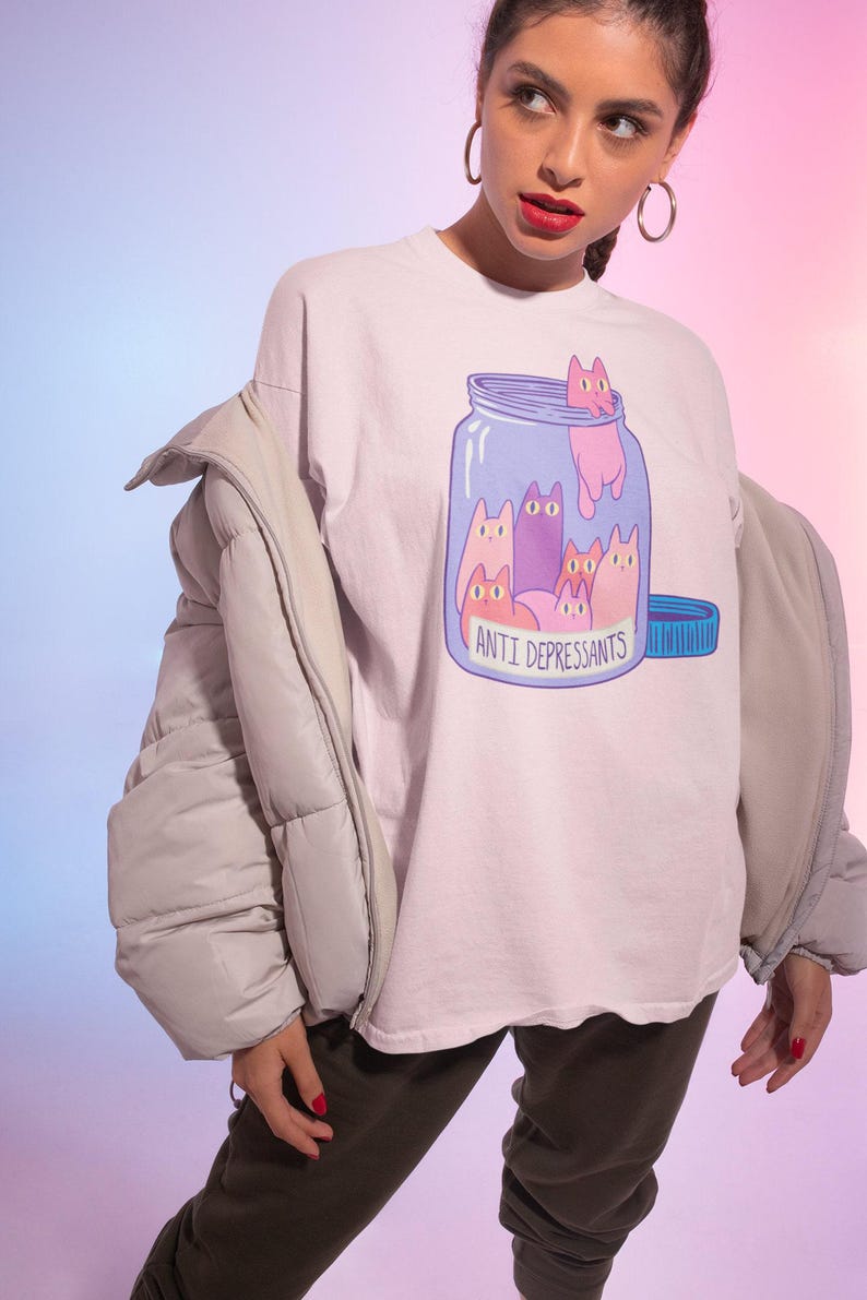 a woman wearing a t - shirt with cats on it