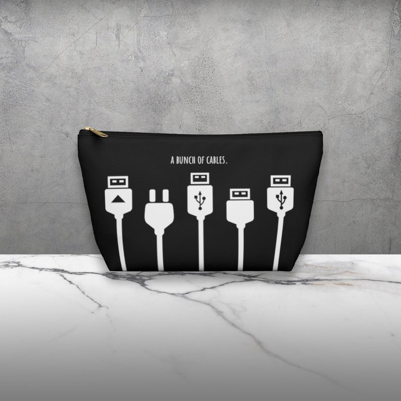 May include: Black zippered pouch with a white graphic of different types of cables and the text "A bunch of cables."
