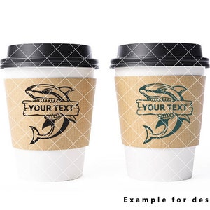 May include: Two white coffee cups with black lids. Each cup has a brown paper sleeve with a black and white shark graphic and the text "YOUR TEXT" on a wooden sign.