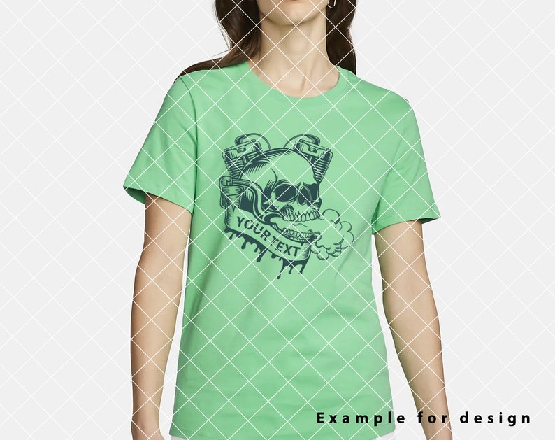May include: A green t-shirt featuring a black and white skull graphic. The skull is wearing a crown and has two pipes coming out of its mouth. The text "YOUR TEXT" is written on a banner below the skull.