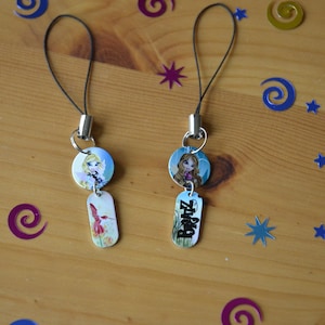May include: Two colourful phone charms featuring cartoon characters with the word "Bratz" on one charm.
