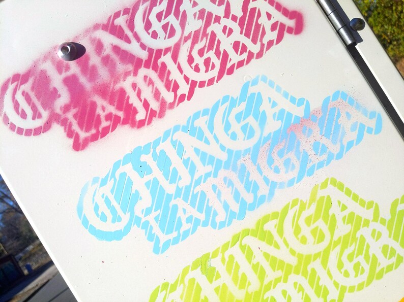 Puede incluir: Superficie blanca con tres dise&ntilde;os de texto coloridos. El dise&ntilde;o superior es rosa, el del medio es azul claro y el inferior es verde. Cada dise&ntilde;o presenta el texto "CHINGA LA MIGRA" en blanco, con un fondo a rayas.