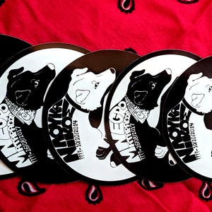 May include: Five black and white round stickers with a dog illustration and text. The text on the stickers reads "Minego", "Mathpaco", "All Riot Dogs Go To Heaven", and dates.