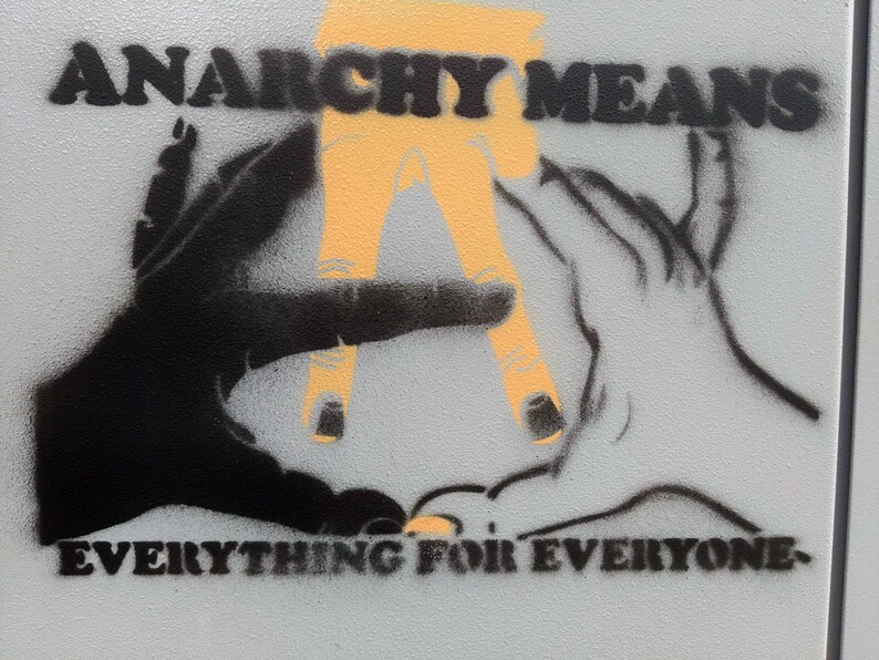May include: A graphic image with the words "ANARCHY MEANS EVERYTHING FOR EVERYONE." The artwork features two hands, one black and one white, with an orange "A" in the center. The design is a stencil style.