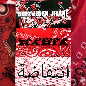 May include: A rectangular design with text in multiple languages, featuring red and white paisley patterns and floral accents. The top section has the text "BERXWEDAN JIYANE" in white. The middle section reads "LA DIGNA RABIA" and the bottom section has Arabic text.