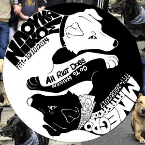 May include: Black and white illustration of two dogs in a yin yang design. The text "All Riot Dogs Go To Heaven" is written on the white dog. The text "NAOYKA NIKROM ???-10/10/2014" is written on the black dog.