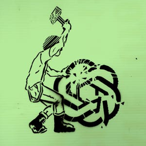 May include: Black and white stencil art on a light green background. The image depicts a person swinging a hammer at a complex, geometric shape. The style is reminiscent of street art or protest art.