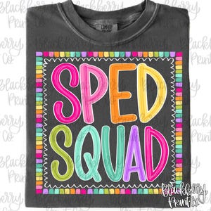 May include: A charcoal gray t-shirt featuring the text SPED SQUAD in colorful, outlined bubble letters. The text is enclosed within a square border made of small, multicolored rectangular blocks. The shirt has a crew neckline and short sleeves.