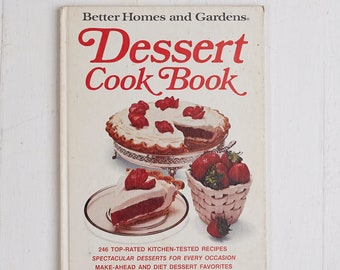 May include: A vintage Better Homes and Gardens Dessert Cook Book with a red and white cover featuring a photo of a strawberry dessert. The book title is in red and white text. The book cover also includes the text "246 Top-Rated Kitchen-Tested Recipes, Spectacular Desserts for Every Occasion, Make-Ahead and Diet Dessert Favorites."