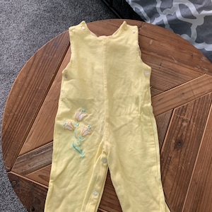 Yellow overalls/pink flowers