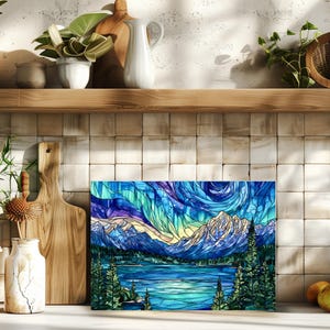 Decorative glass cutting board with night sky mountain art styled on kitchen counter