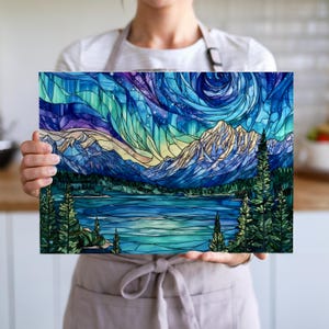 Chef holding mountain night sky glass cutting board showing scale and landscape artwork; a unique gift for chefs