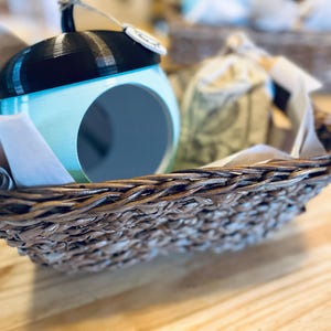 May include: A set of three ceramic mugs with a speckled, matte finish. The mugs are in shades of cream, light gray, and dark gray. Each mug has a simple, minimalist design, perfect for coffee or tea.