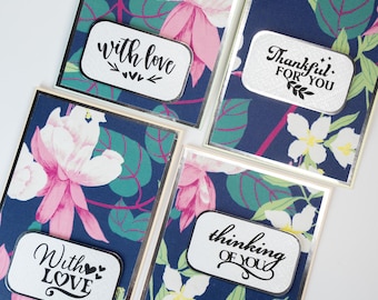 May include: Four handmade greeting cards with floral patterns and silver accents. The cards have different messages: "With love", "With love", "Thinking of you", and "Thankful for you".