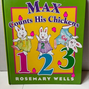 May include: A hardcover children's book titled Max Counts His Chickens by Rosemary Wells. The green cover features three white rabbits wearing overalls with the numbers 1, 2, and 3, surrounded by small pink chick illustrations and large colorful numbers.