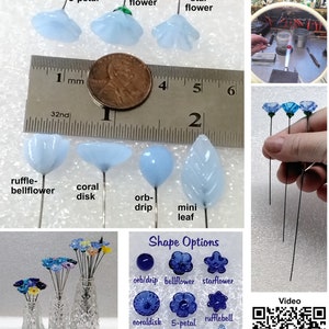 May include: A close-up of various glass flower shapes, including a bellflower, starflower, ruffle-bellflower, coral disk, orb-drip, and mini leaf. The flowers are on wire stems and are approximately 1 cm in size. The image also includes a ruler for scale and a video icon.
