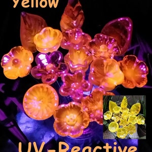 May include: A collection of yellow, UV-reactive glass flower and leaf shapes. The word "Yellow" is at the top, and "UV-Reactive" is at the bottom. The flowers and leaves are in various sizes and shapes.
