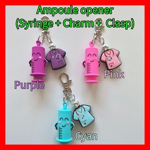 May include: Keyrings featuring ampoule openers in purple, pink, and cyan, each with a syringe charm and a medical scrubs charm. The keyrings have a clasp. Text on the image reads "Ampoule opener (Syringe + Charm + Clasp)".