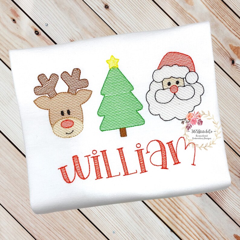 May include: Embroidered Christmas design featuring a reindeer, a Christmas tree, and Santa Claus with the name "William" in red.