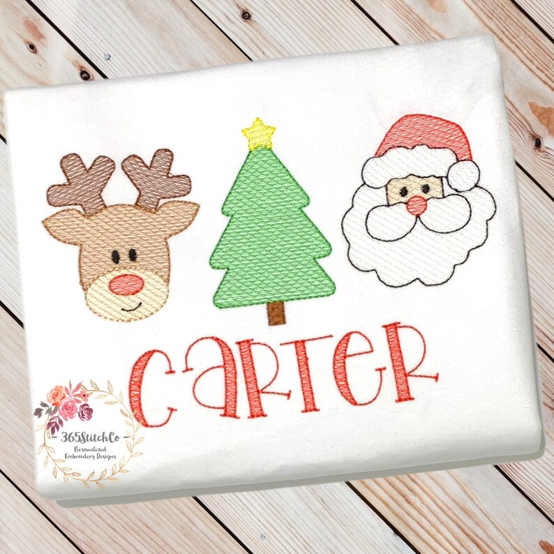 May include: Embroidered Christmas design featuring a reindeer, a Christmas tree, and Santa Claus. The design includes the name "Carter" in red.
