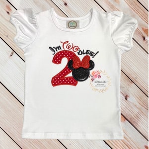 May include: White short-sleeved shirt with red and black embroidered design. The design features a red number "2" with white polka dots and a black Mickey Mouse head with a red bow. The text "I'm Two-dles!" is embroidered above the design.