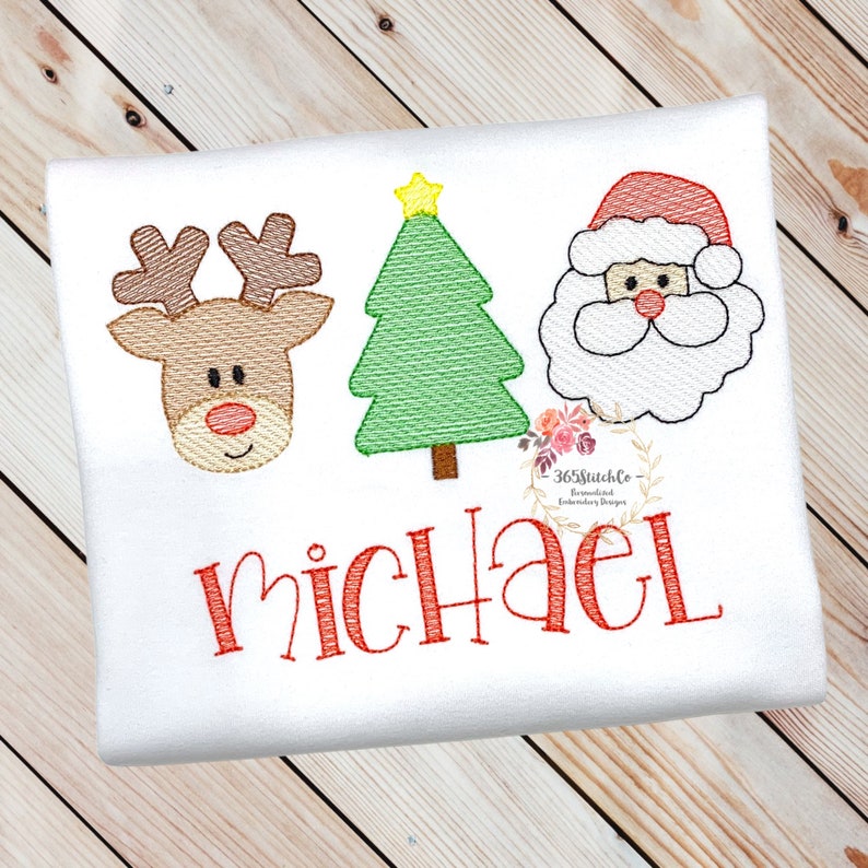 May include: A white onesie with a red reindeer, green Christmas tree, and Santa Claus face embroidered on it. The name "Michael" is embroidered in red below the images.