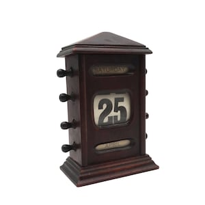 May include: A dark brown wooden perpetual calendar with a white card showing the date "25" and the month "APRIL". The day of the week is "SATURDAY".