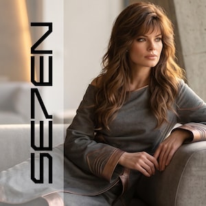 May include: A long-sleeved grey dress featuring brown leather-like trim on the cuffs and shoulders, with the text SE7EN printed vertically in black on the left side. The garment has a wide neckline and a smooth, structured fabric construction.