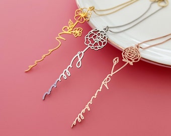 May include: Three delicate gold, silver, and rose gold necklaces with a flower and a personalised name on each. The necklaces are displayed on a white plate against a pink background.