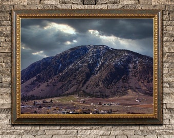 Sun Peaking Through the Clouds on a Dark Mountain Print