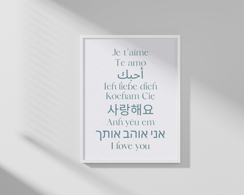 May include: A white framed print with the phrase "I love you" written in multiple languages, including English, French, Spanish, German, Korean, Arabic, and Hebrew.