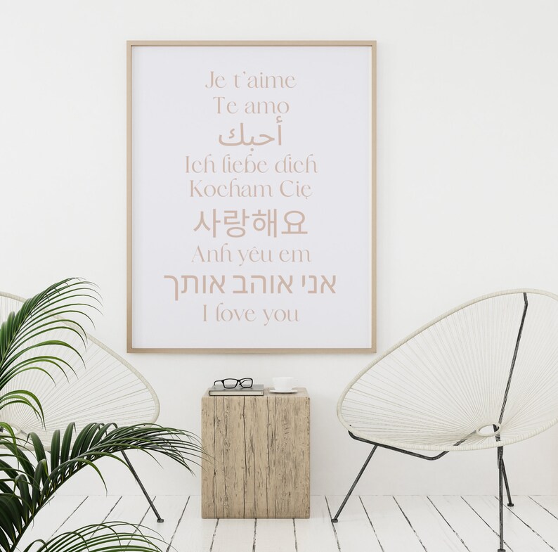 May include: A white framed poster with the words "Je t'aime", "Te amo", "أحبك", "Ich liebe dich", "Kocham Cię", "사랑해요", "Anh y&ecirc;u em", "אני אוהב אותך", and "I love you" written in different languages.