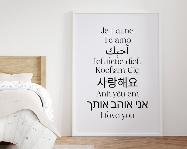 May include: A white framed print with the phrase "I love you" written in 10 different languages, including English, French, Spanish, German, Polish, Arabic, Vietnamese, Korean, and Hebrew.