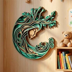May include: A layered wooden wall art piece depicting a woman's face and flowing hair, with a tree-like design. The artwork features shades of green, brown, and natural wood tones. The piece is mounted on a light-colored wooden wall.