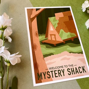 May include: A retro-style illustration of a wooden cabin with a green roof, surrounded by trees and a pond. The text "Welcome to the Mystery Shack" is printed below the image.