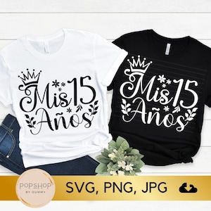 May include: Two t-shirts with the text "Mis 15 Años" in black lettering with a crown and floral accents. The text is on a white t-shirt and a black t-shirt.