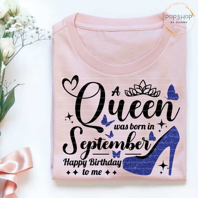May include: A pink t-shirt with a black graphic that says "A Queen was born in September. Happy Birthday to me." The graphic also includes a blue high heel shoe, a crown, and butterflies.