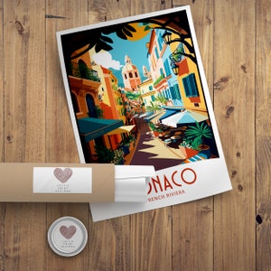 May include: A colorful illustration of a street scene in Monaco, French Riviera. The image features buildings with terracotta roofs, palm trees, and people sitting at outdoor cafes. The text "Monaco, French Riviera" is printed at the bottom of the image.