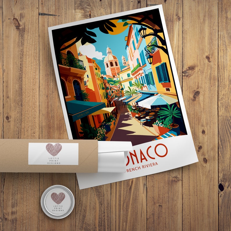 May include: A colorful illustration of a street scene in Monaco, French Riviera. The image features buildings with terracotta roofs, palm trees, and people sitting at outdoor cafes. The text "Monaco, French Riviera" is printed at the bottom of the image.