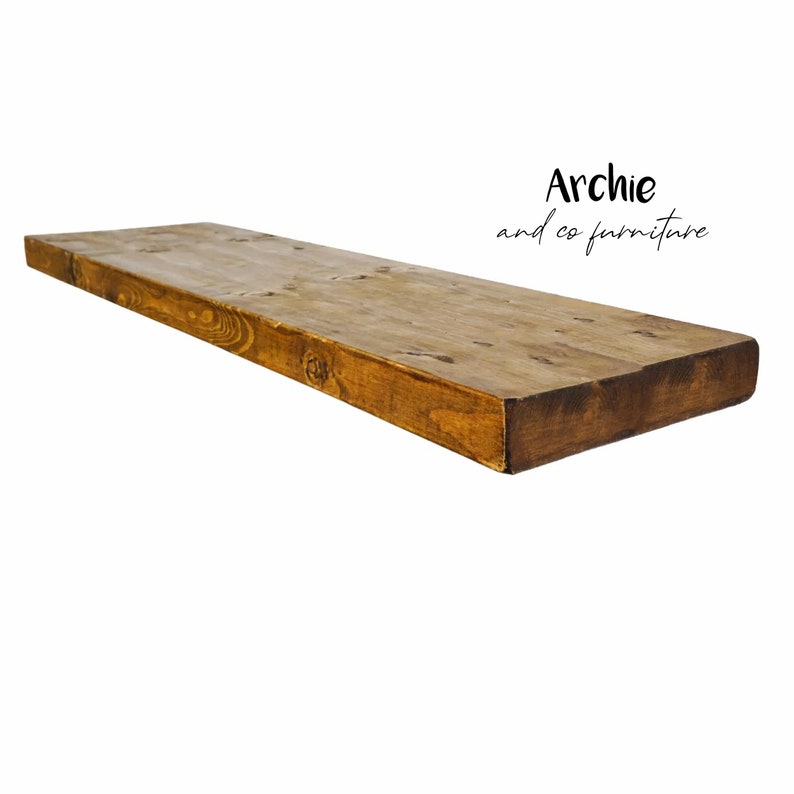May include: A long, rustic wooden shelf with a natural brown stain. The shelf is made of reclaimed wood and has a slightly distressed look.
