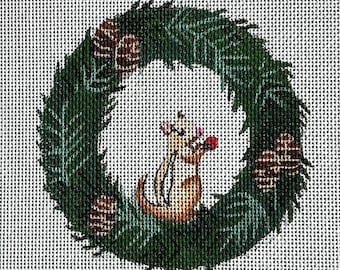May include: A green Christmas wreath with a brown squirrel holding a red berry. The wreath is decorated with pine cones.