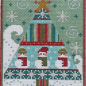 May include: Needlepoint Christmas tree design with a gold star on top, featuring three snowmen with red scarves. The tree has red, green, and blue stripes, with a green and red border. The background is light green.