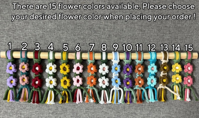 May include: Fifteen macrame flower keychains hanging from a wooden dowel, numbered 1 through 15. Each keychain features two stacked flowers with varying color combinations. Text reads: There are 15 flower colors available. Please choose your desired flower color when placing your order!