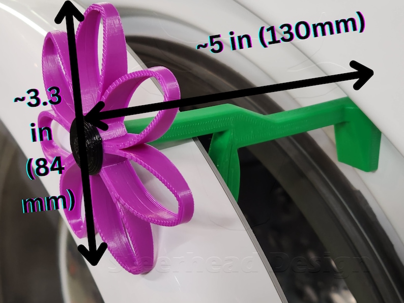 May include: A 3D printed purple flower with a black center, attached to a green plastic handle. The flower measures approximately 3.3 inches (84 mm) in diameter and the handle is about 5 inches (130 mm) long.