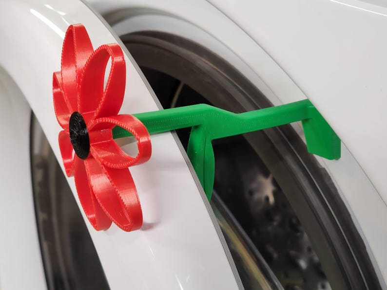red flower door prop holding washing machine door