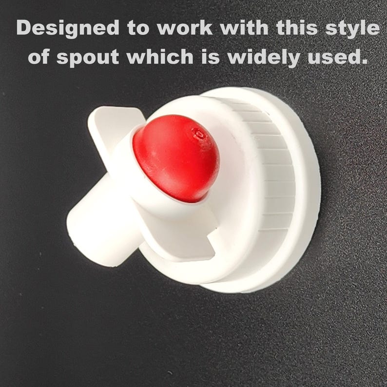 May include: White plastic bottle spout with a red push-down button. The spout is designed to fit a standard bottle.